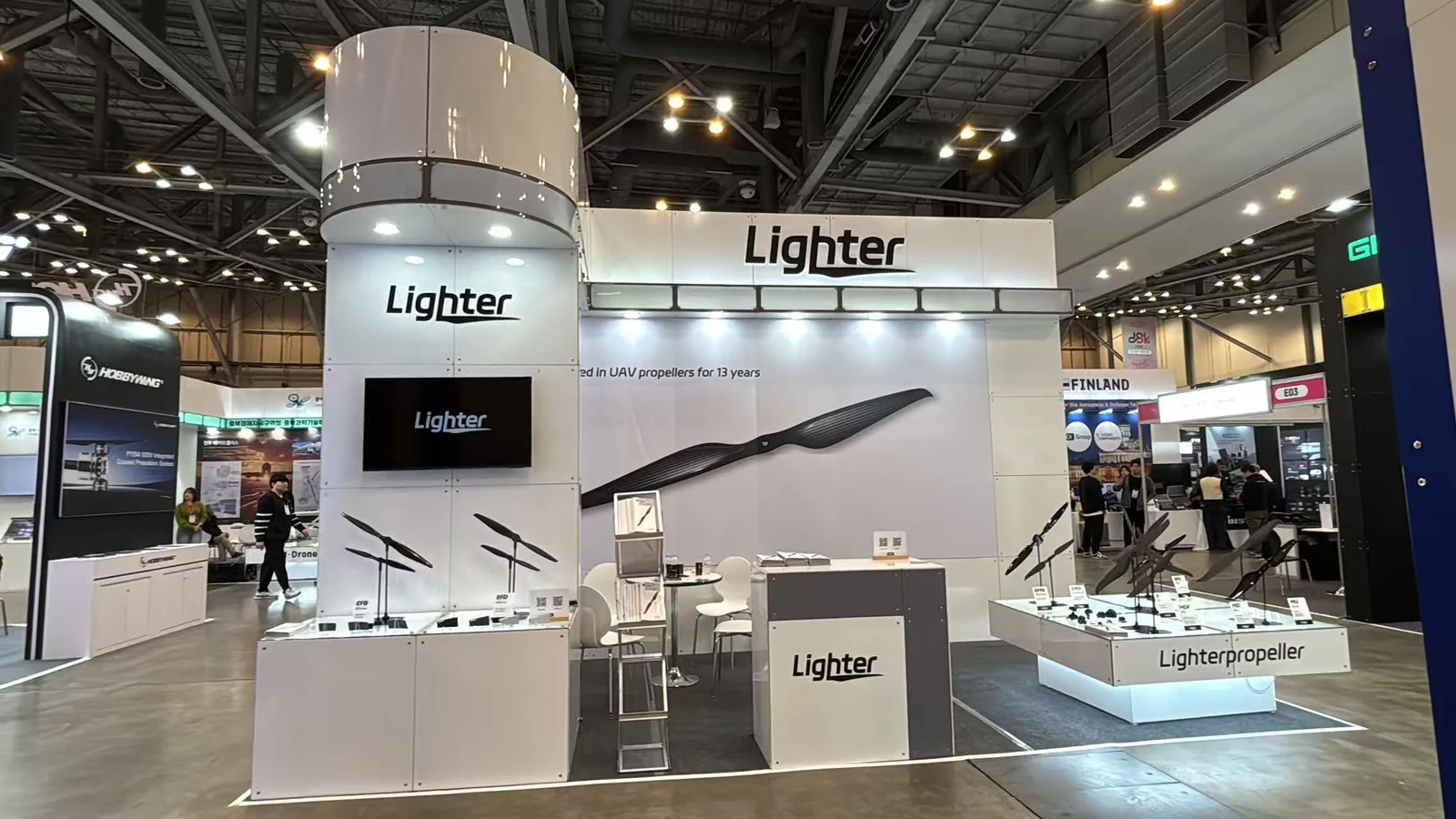Lighter Propeller stand with a branded column in a large exhibition hall